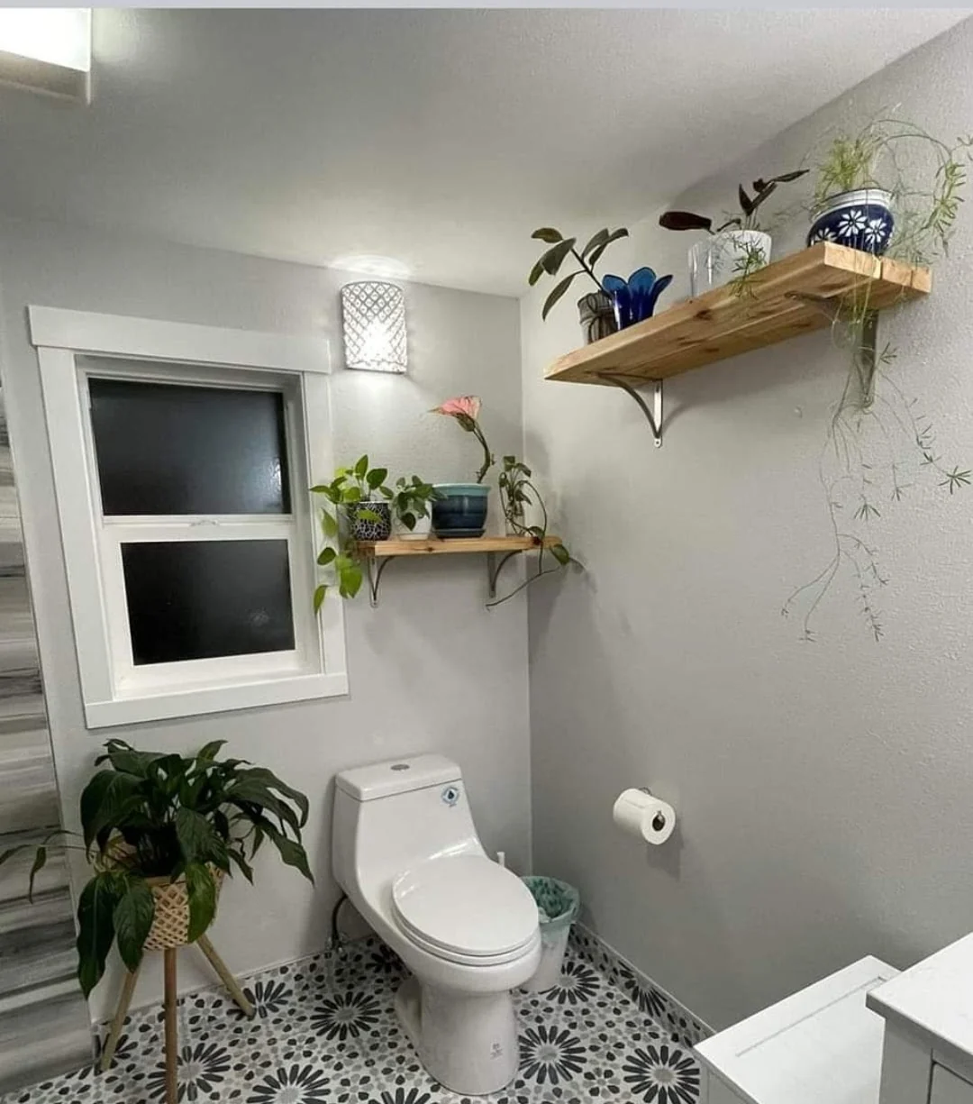 Bathroom remodel in Renton, WA, with a curbless shower, new window, heater/exhaust-fan combination, mosaic tile, and custom cedar shelves.