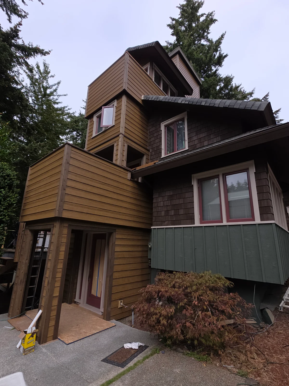 Luxury Proctor District restoration featuring waterproof balconies, pre-stained cedar siding, matching trim, and rebuilt structural supports