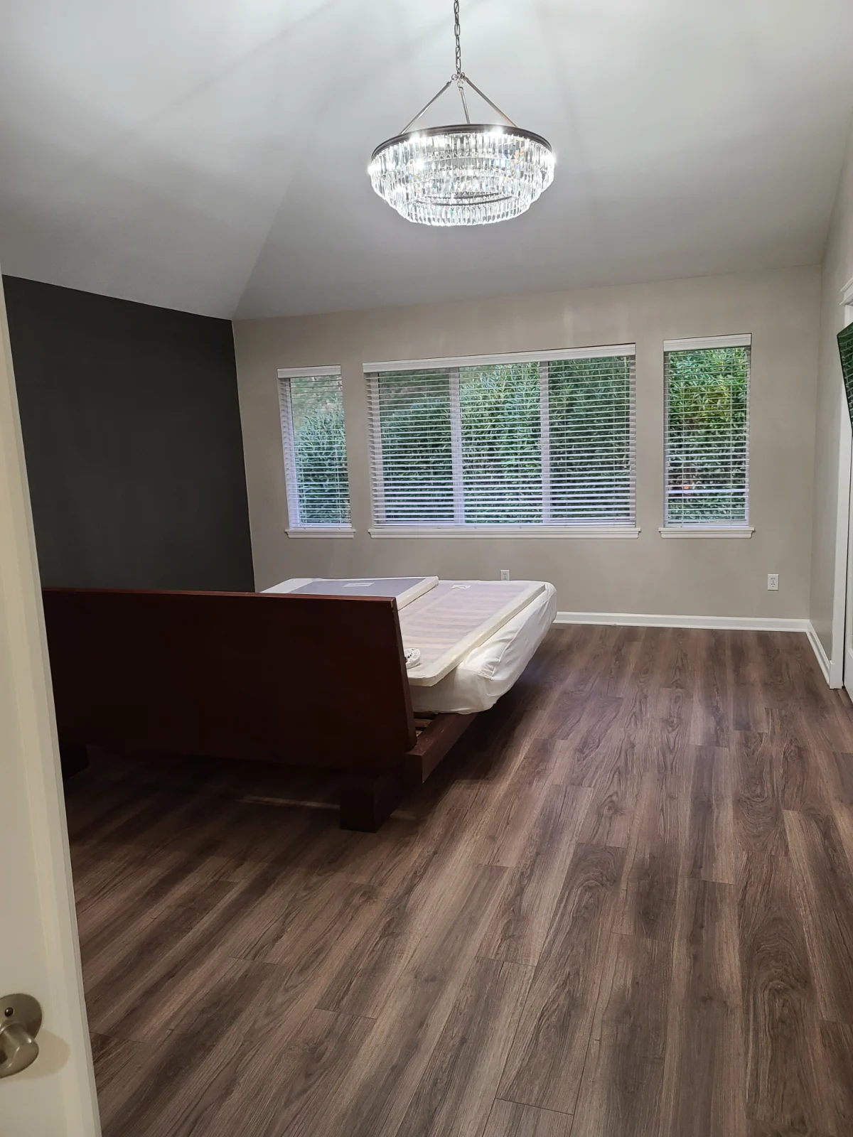Luxury bedroom with charcoal accent wall and white trim